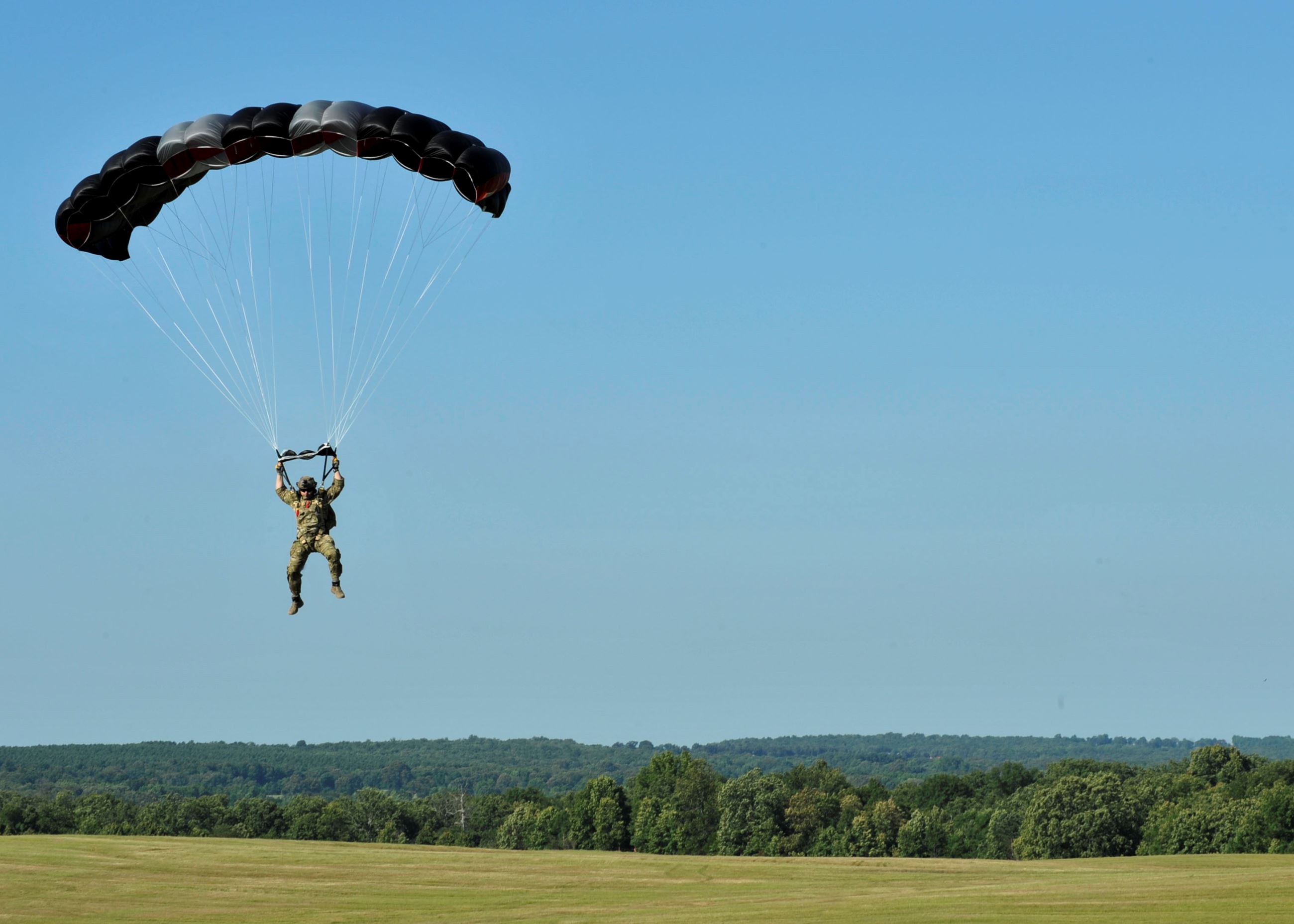 An Airman from 19th Operations Support Squadron prepares to land at Blackjack DZ