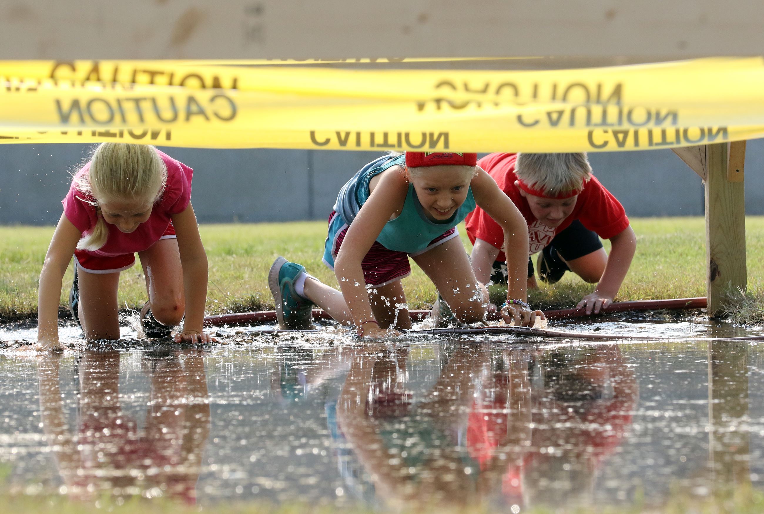 Kids crawling in mud pit