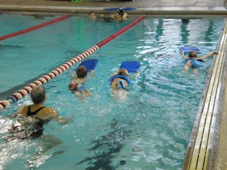 Children Learning to Kick Swim