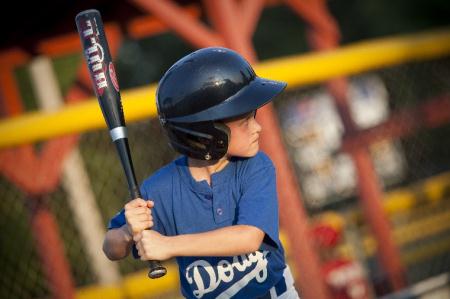 Child playing baseball at Excell Park